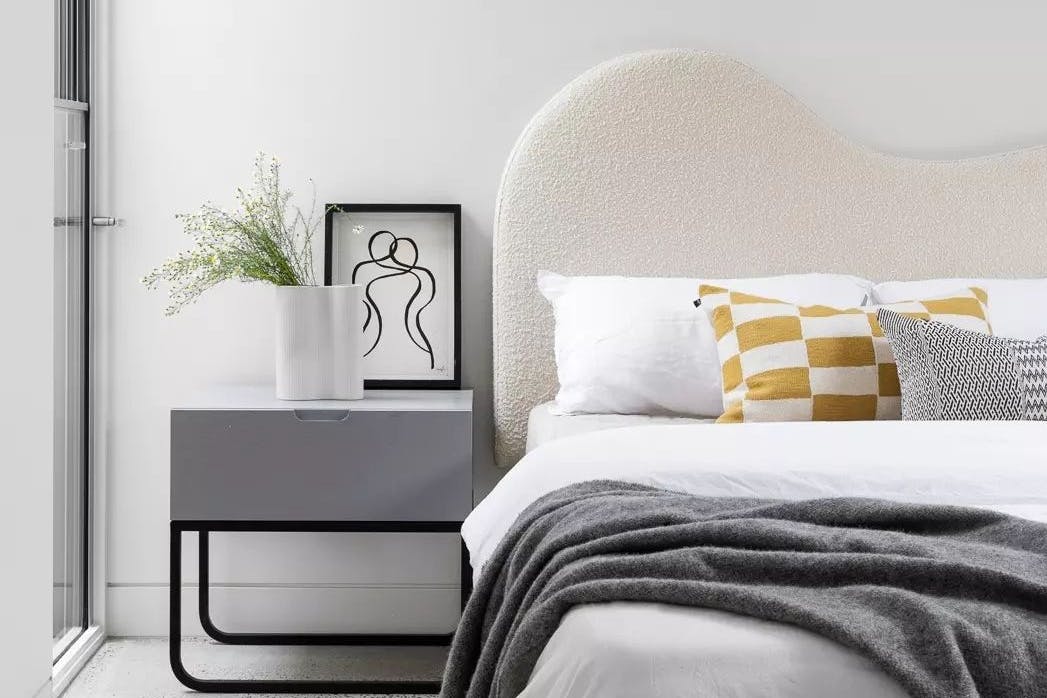 A bed and bedside table